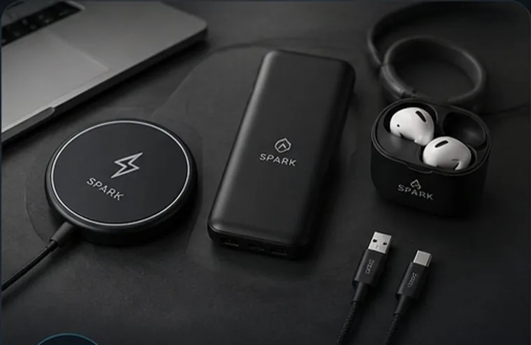 Branded wireless charger, power bank, earbuds, and cable with a custom Spark logo