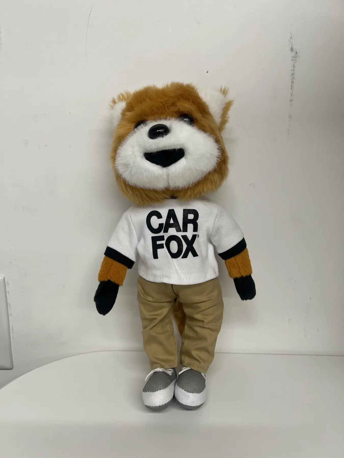CARFAX Car Fox mascot plush in a branded white shirt