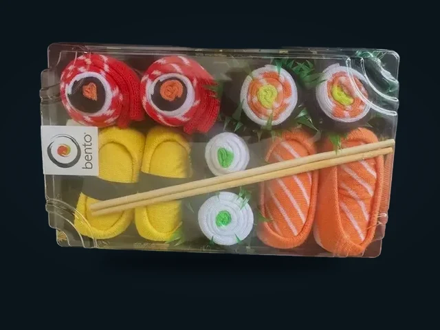Bento sushi-themed socks arranged like pieces of sushi in a gift tray